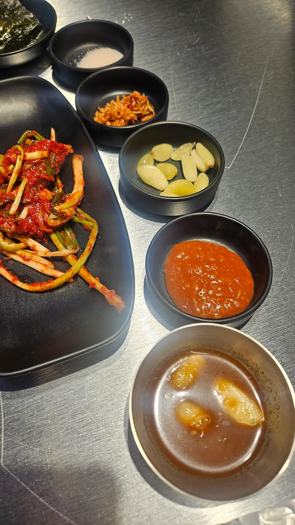 Dish of anchovy sauce set in the middle of the grill