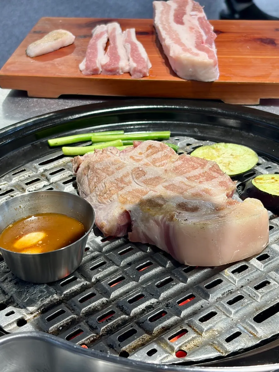 Pork neck and pork belly on the grill