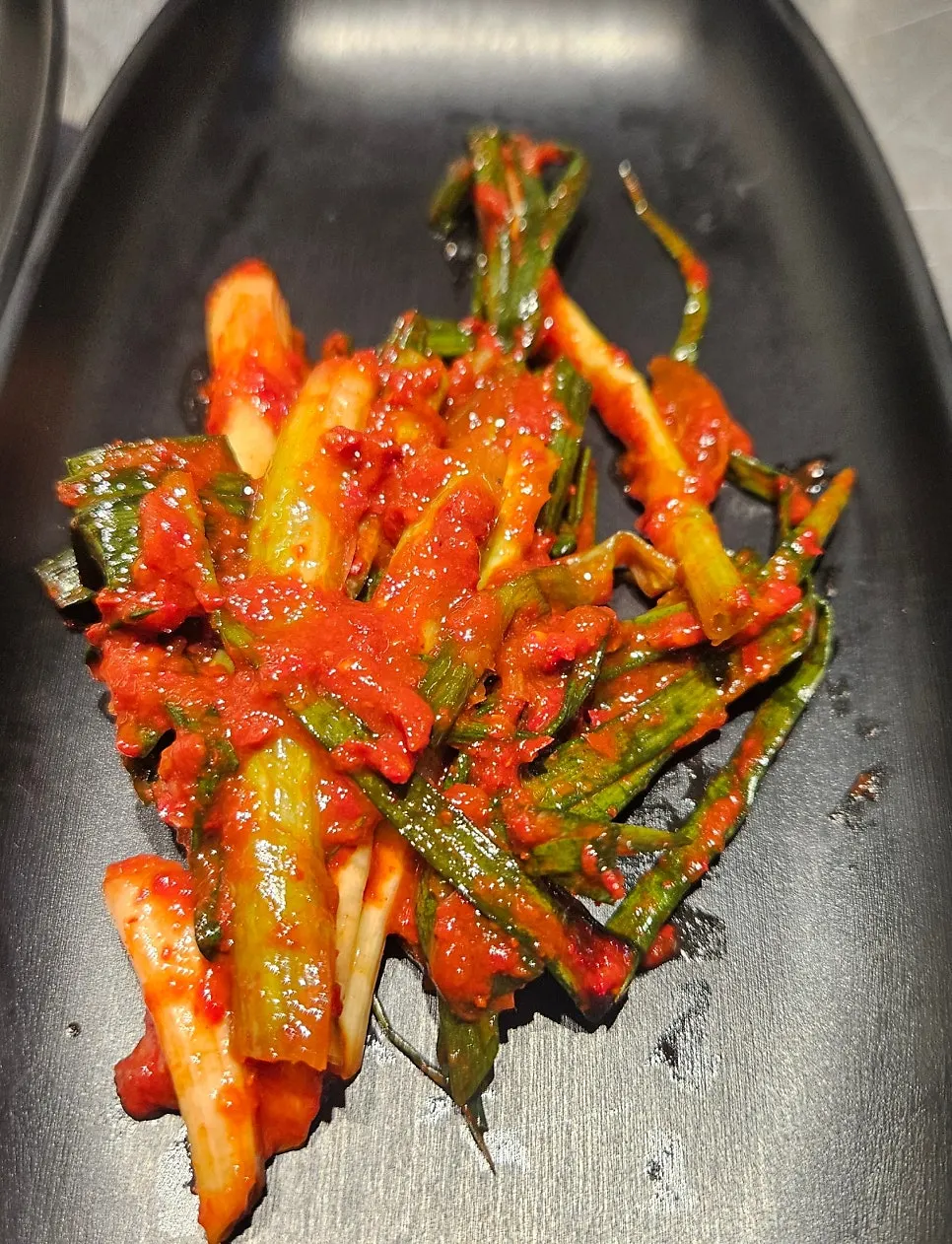 Green onion kimchi and seasoned bean sprouts among other side dishes