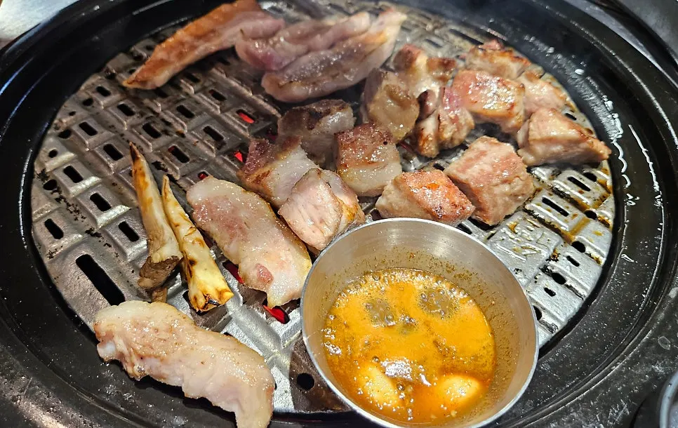 Staff placing meat on the grill