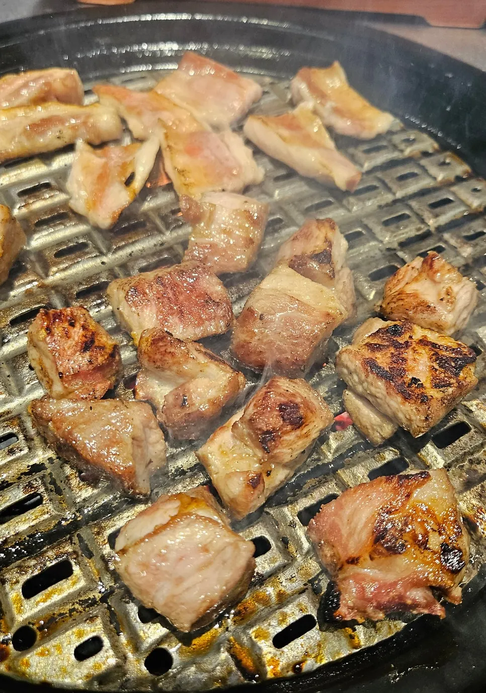 Pork neck and vegetables cooking on the grill