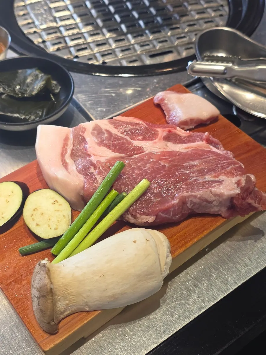 Thick pork neck and gabrisal on a wooden cutting board