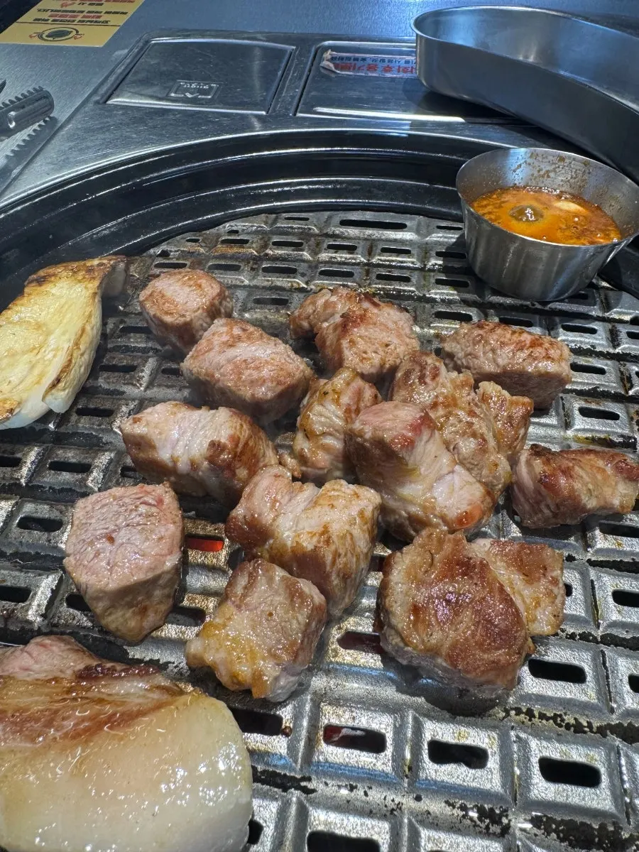 Staff grilling meat on the grill plate