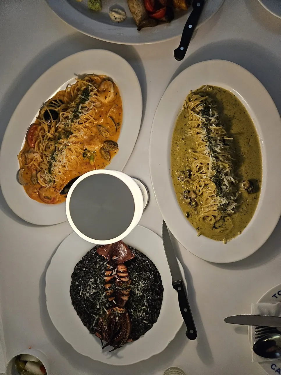 Squid ink risotto topped with a whole squid