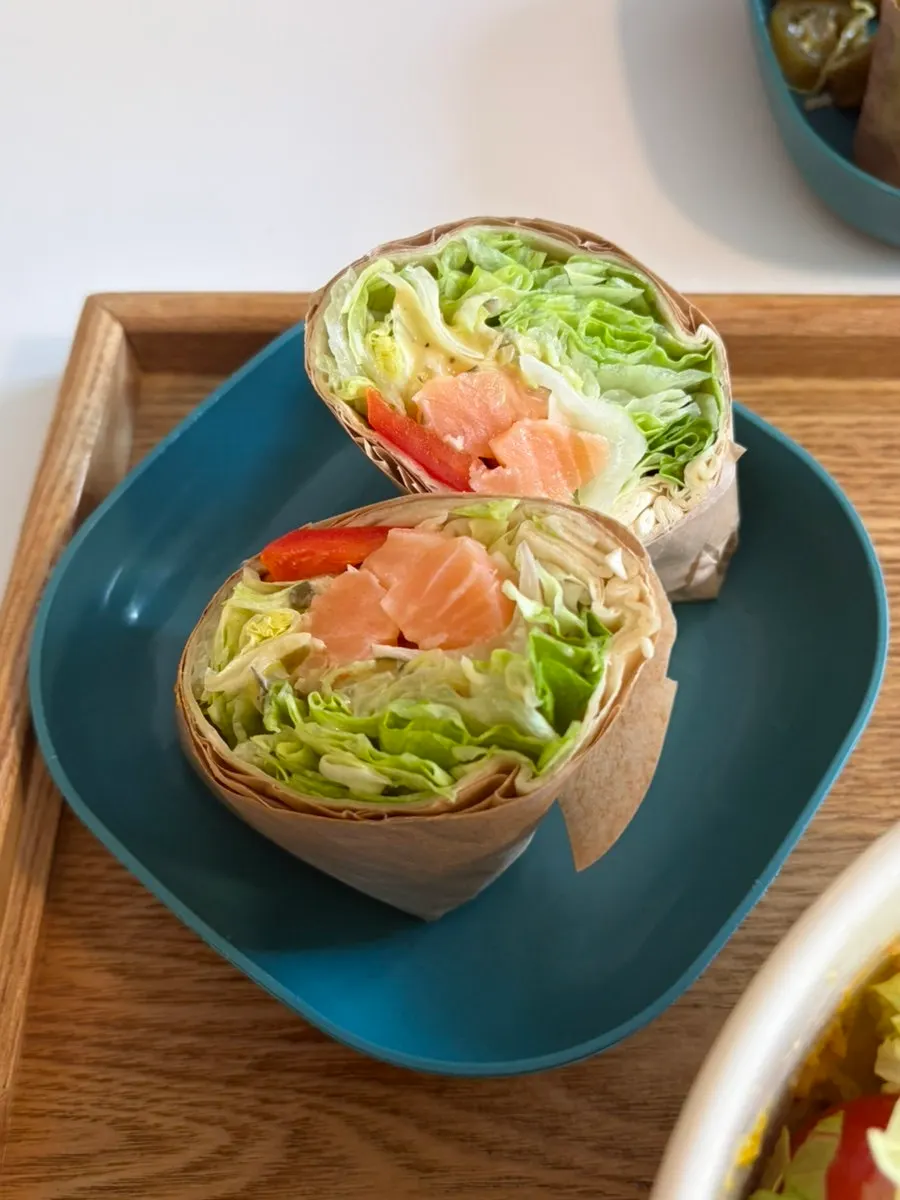 Salmon tortilla wrap and bulgogi sandwich, each eaten half