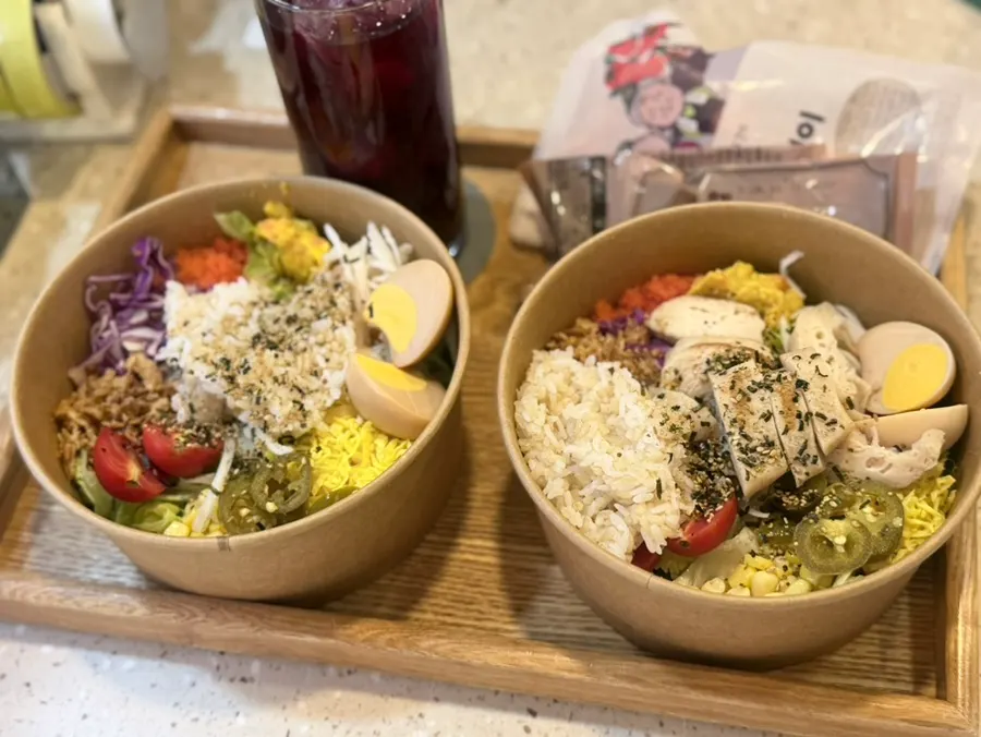 A table set with the 100% fresh poke salad and chicken breast poke