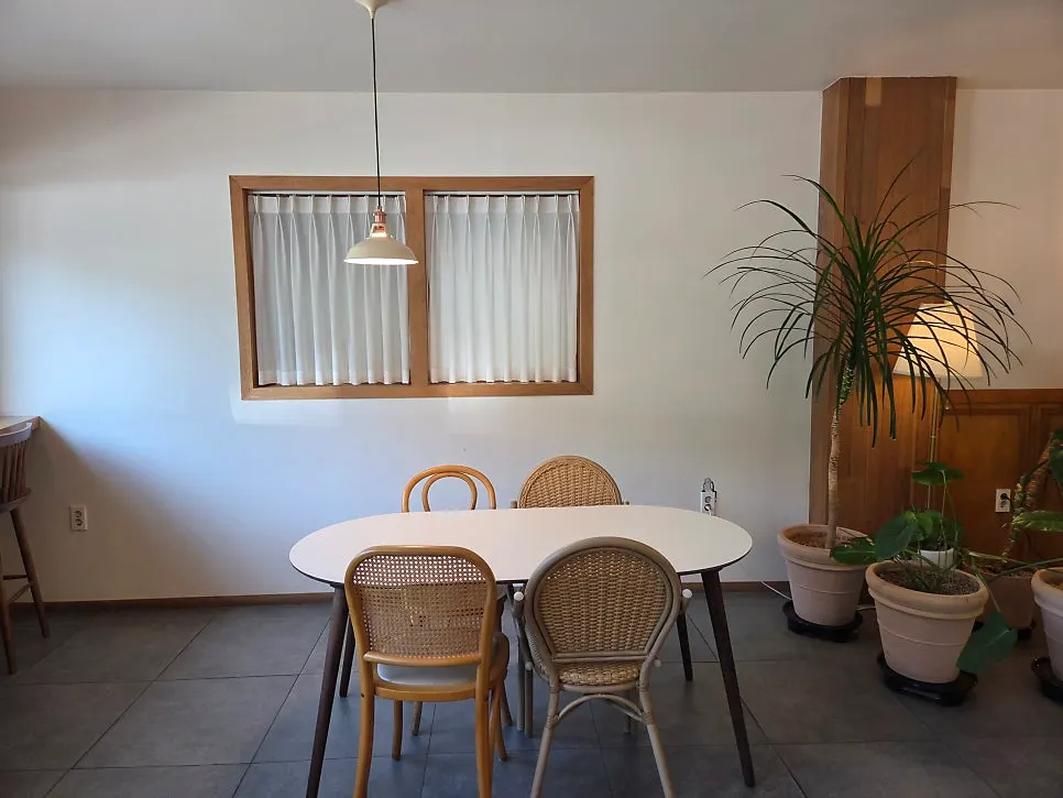 Café interior with white walls and wood-tone furniture