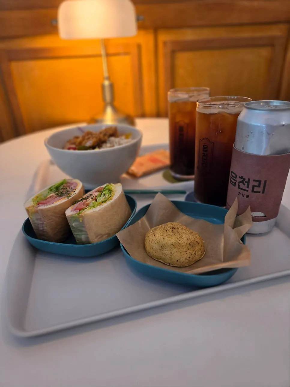 Table setting with chicken poke and sandwich