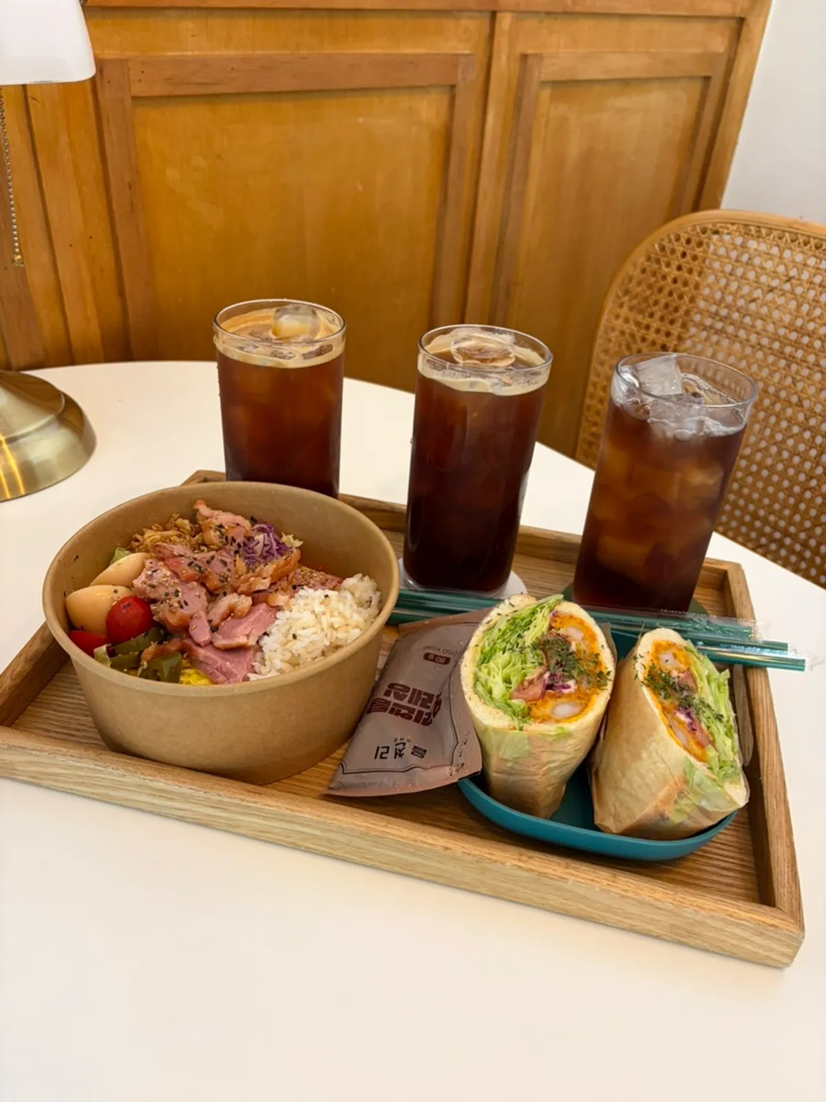 Smoked duck poke bowl and shrimp sandwich set on the table