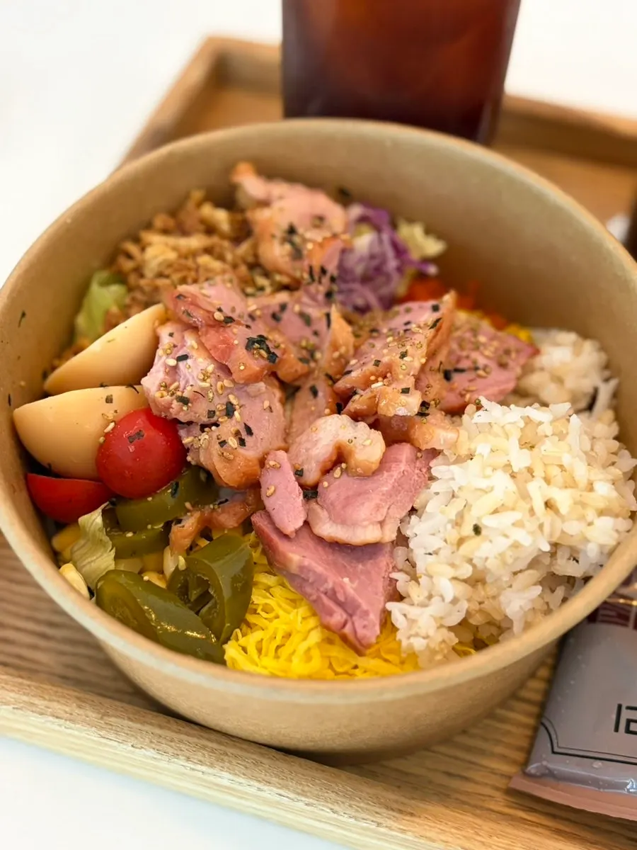 Poke bowl topped with brown rice and smoked duck