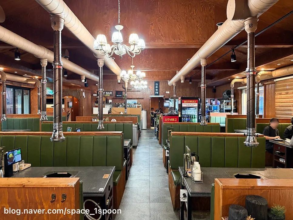 Interior with wood-tone decor and green seating