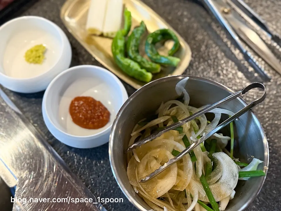 Self-serve bar with lettuce, perilla leaves, and kimchi