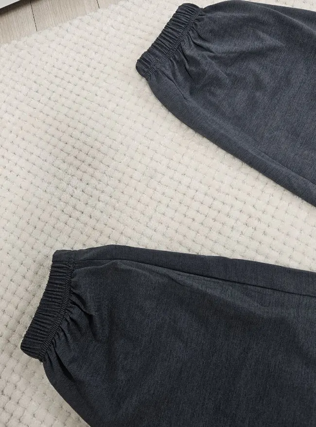 Material detail of the lightweight charcoal tracksuit