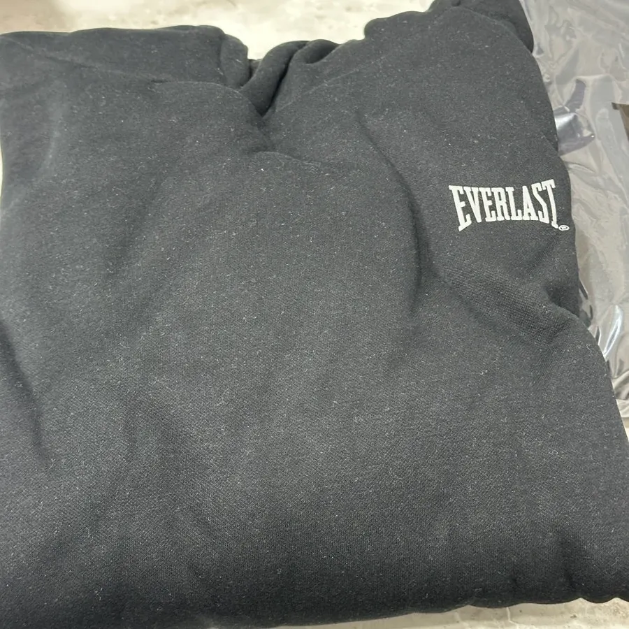 Front of black hooded zip-up and jogger pants