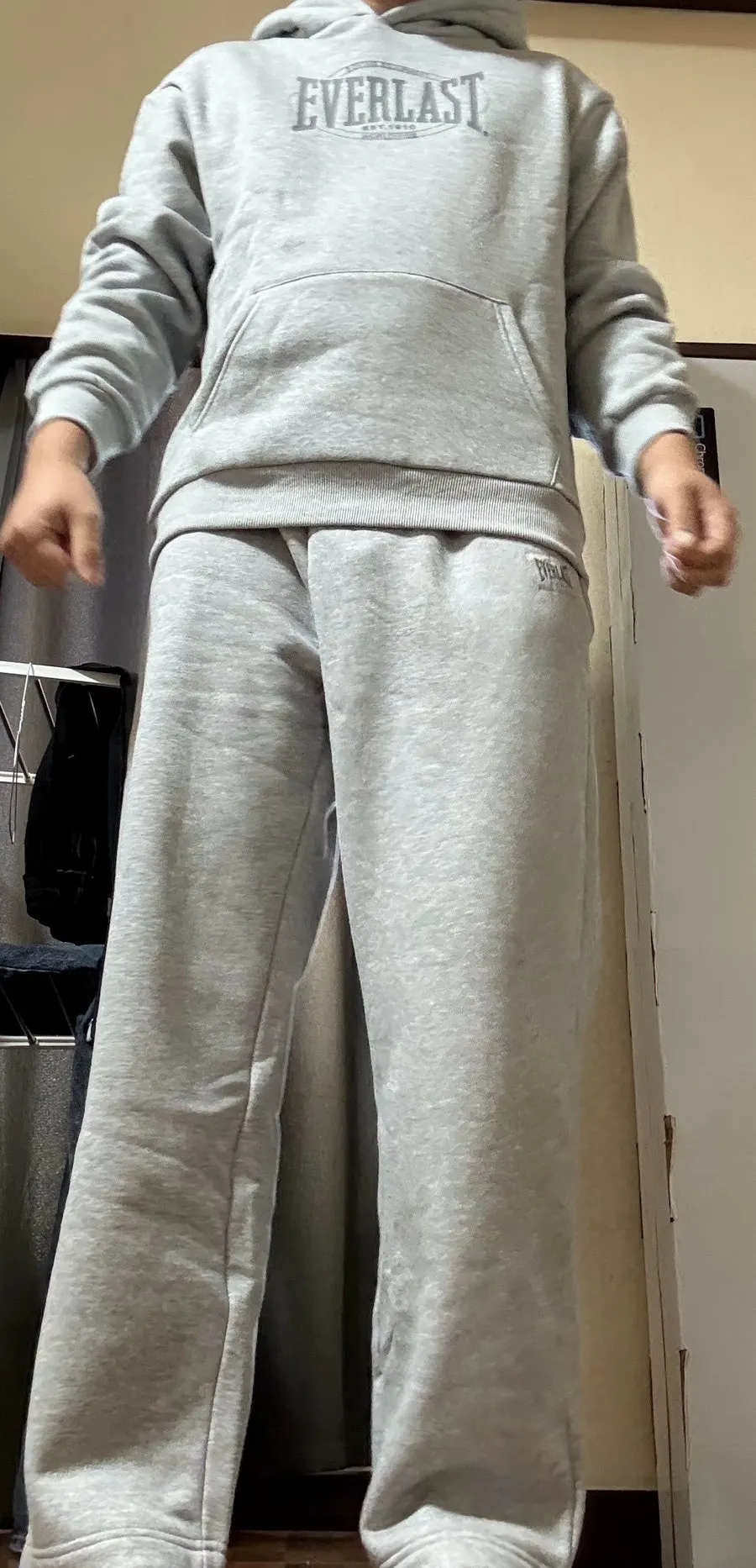 Full-body view of the tracksuit's straight silhouette