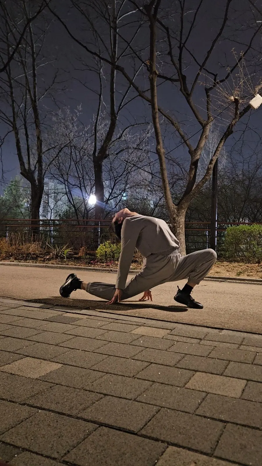 Jogger pants worn while stretching in a park