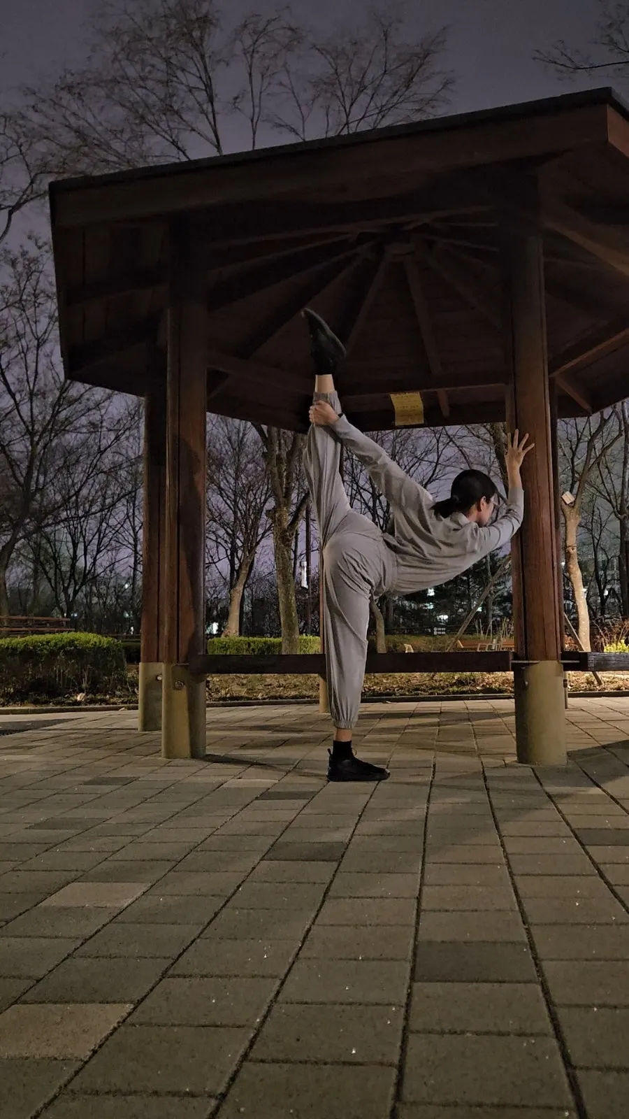 Stretching with legs apart while wearing the training set