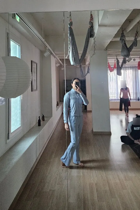 Running jacket and bootcut pants worn for yoga