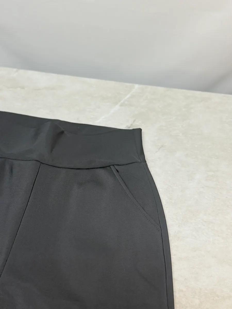 Black bootcut pants worn at top-of-foot length