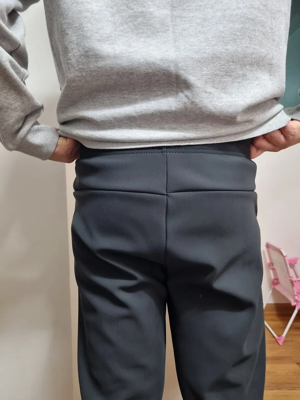Fleece-lined pants with side panels worn