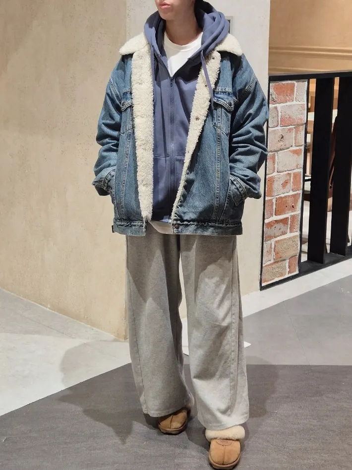 Wearing a loose hooded zip-up tracksuit