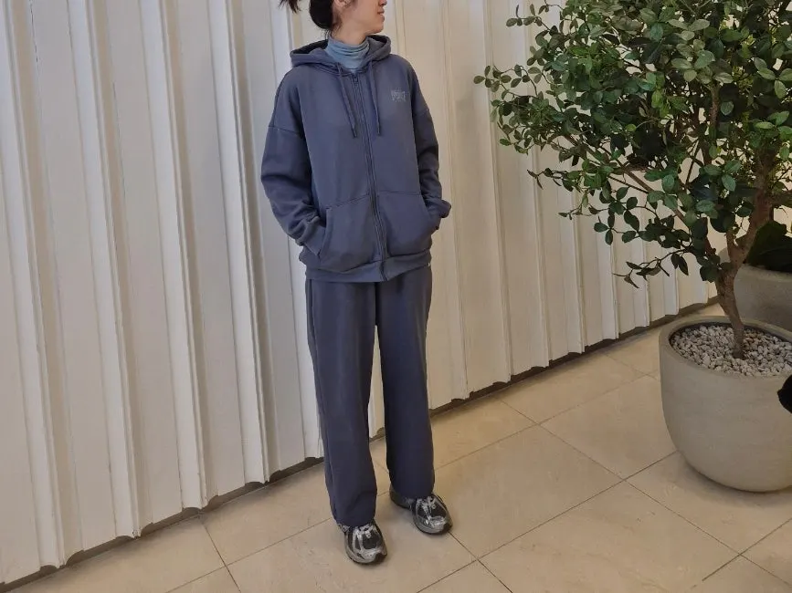 Wearing the hooded zip-up with the zipper closed