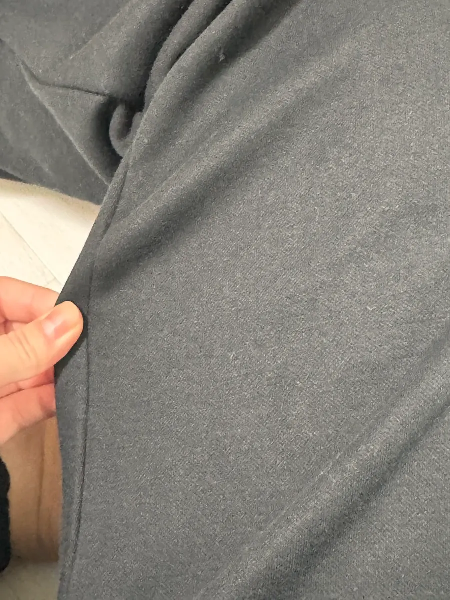 Detail of the black training pants hem while worn