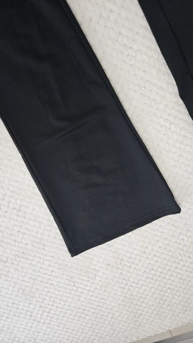 Black running top and pants set worn as everyday clothing