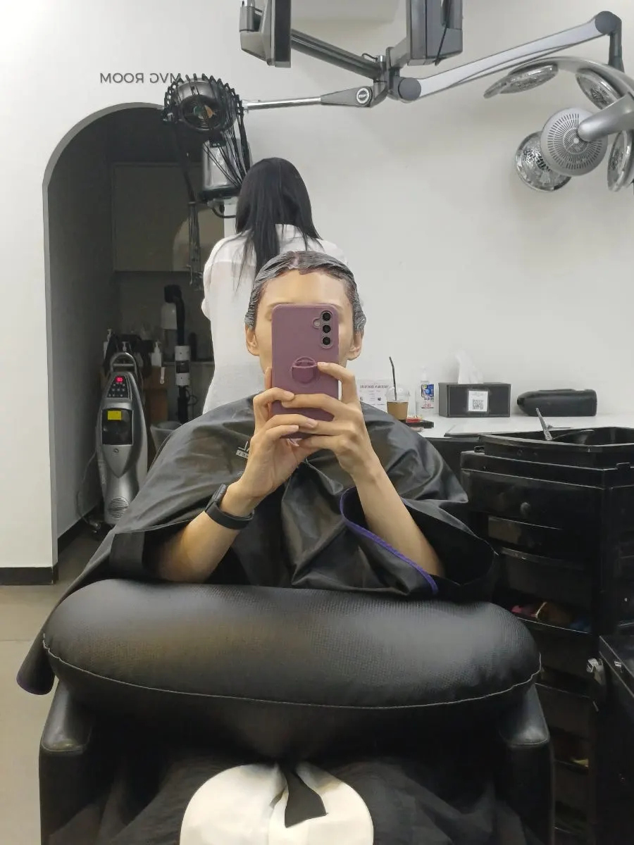 Chocolate brown dyed hair looking calm under indoor lighting