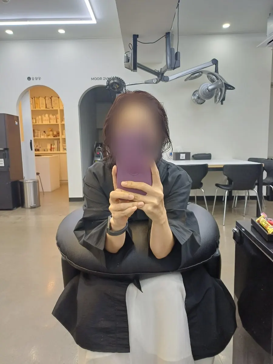 Chocolate brown hair color with a burgundy tint in sunlight