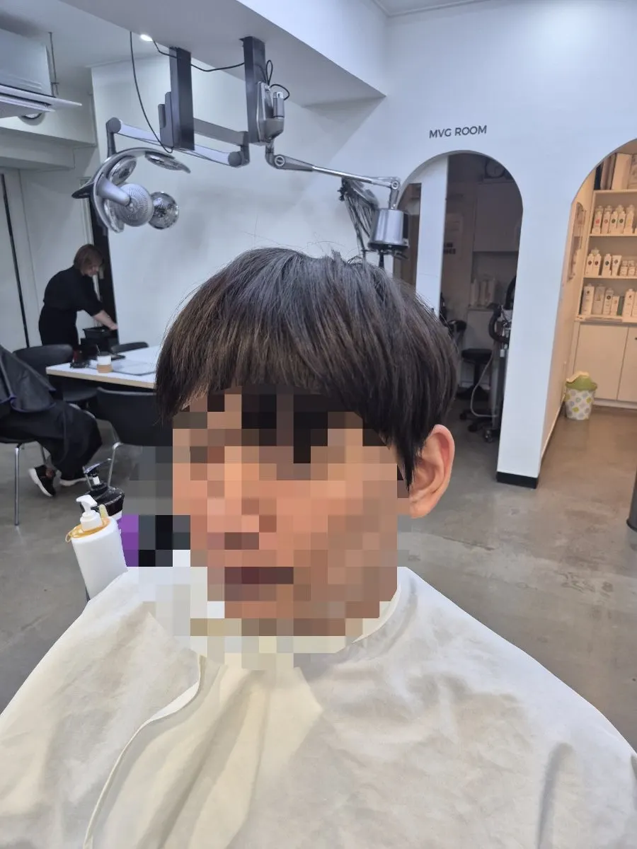 Long, grown-out hair before the cut