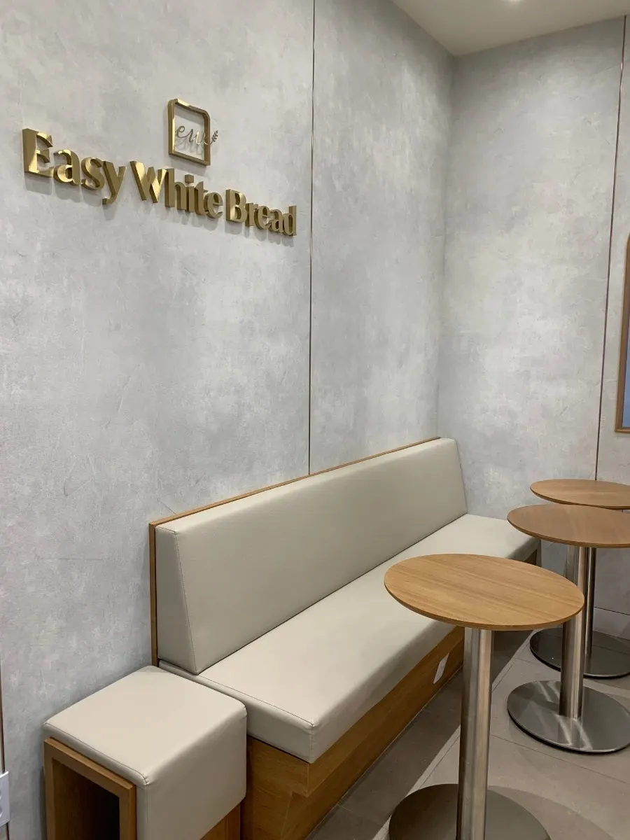 Signature menu sign and waiting chairs in front of the store