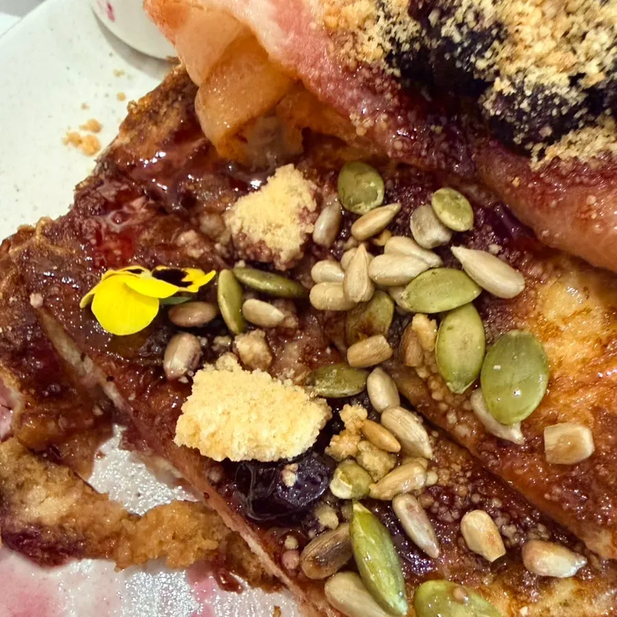 Brunch plating topped with edible flowers at Famous Benny