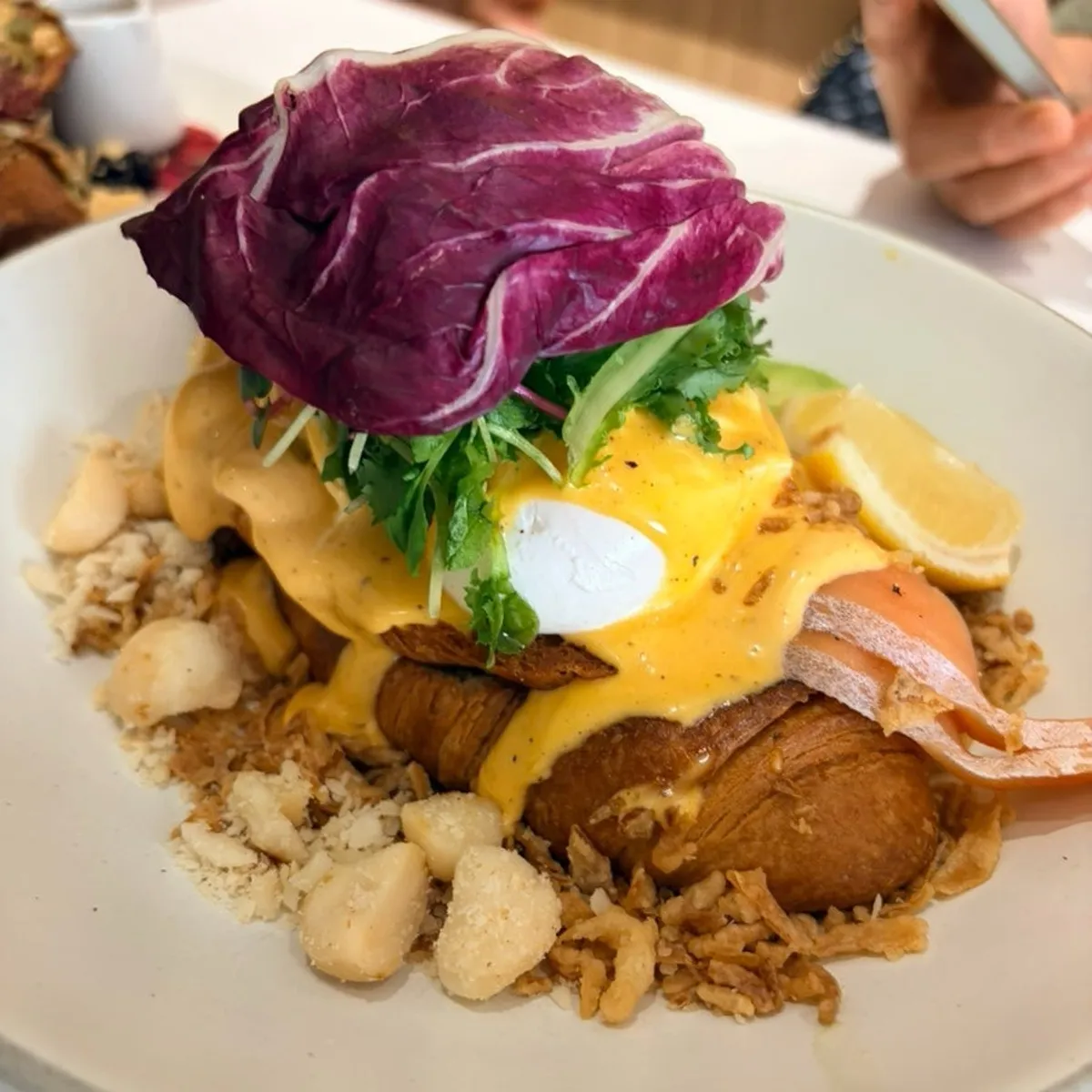 The Famous Benny with poached egg and salmon on a croissant