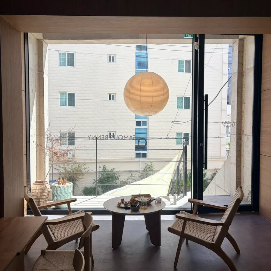 Photo-spot seating at Famous Benny lit by floor-to-ceiling windows