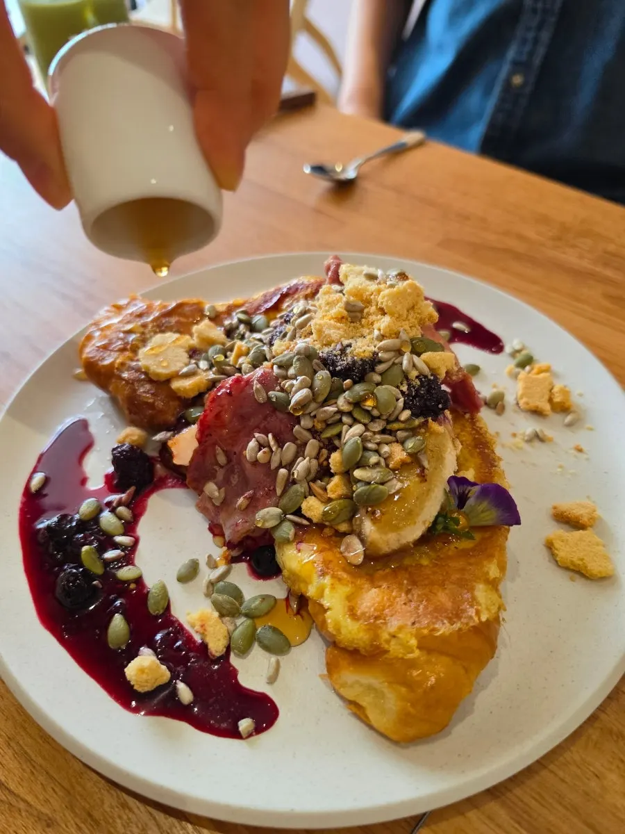 Maple syrup being drizzled over the French toast