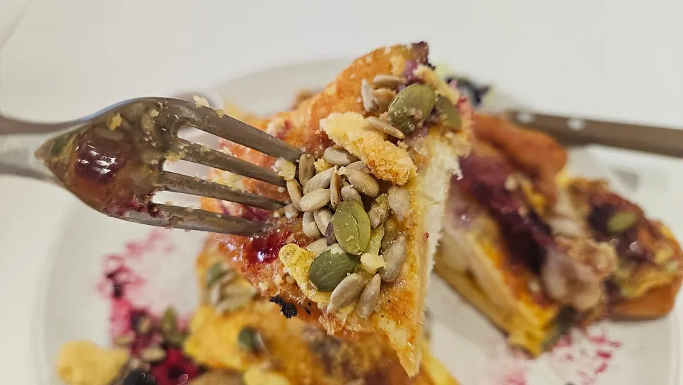Edible flowers and berry sauce on the French toast