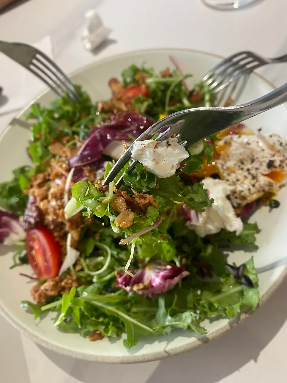 Close-up of house salad with poached egg on top