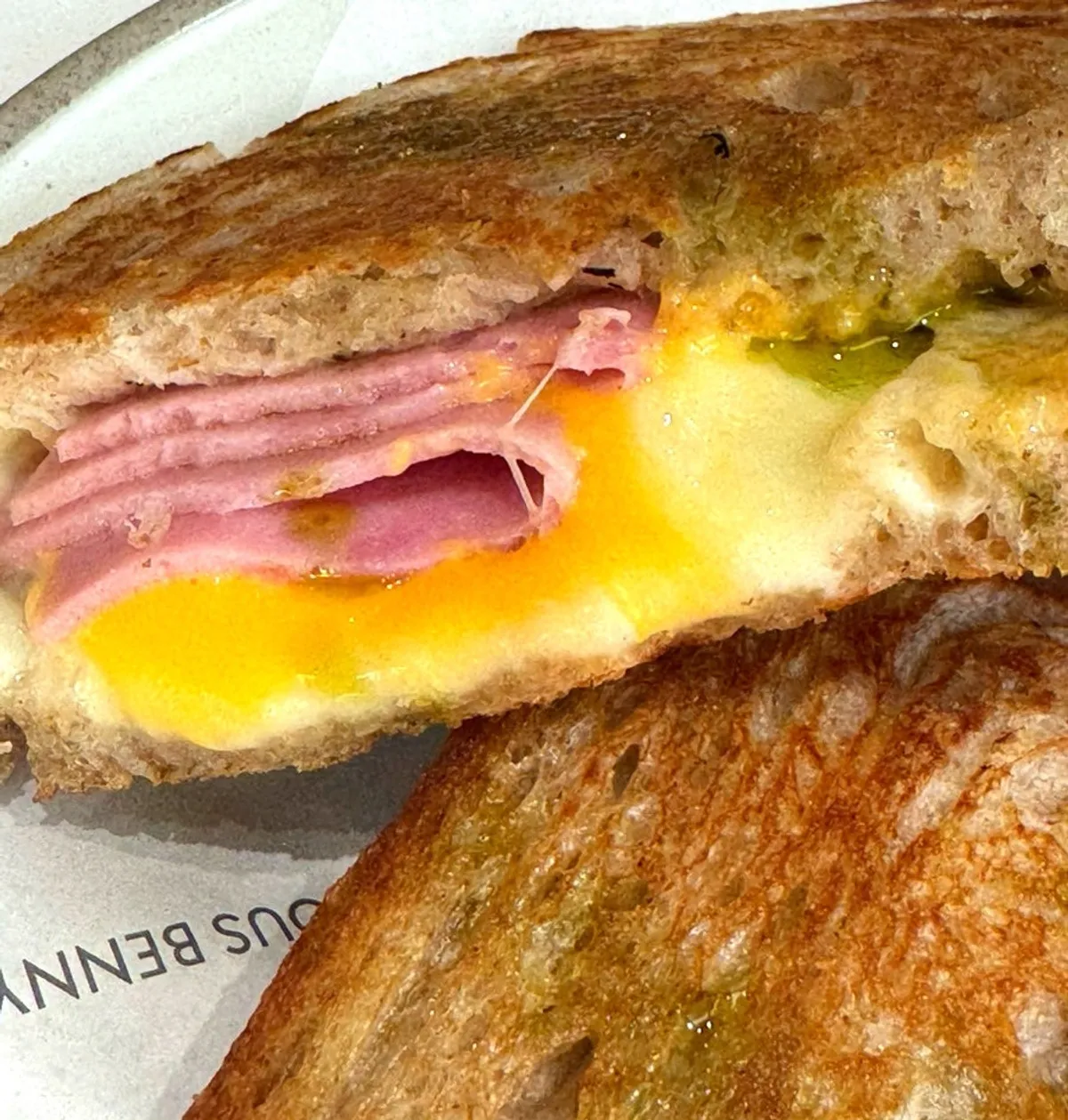 Cross-section of ham cheese toast cut in half with melted cheese