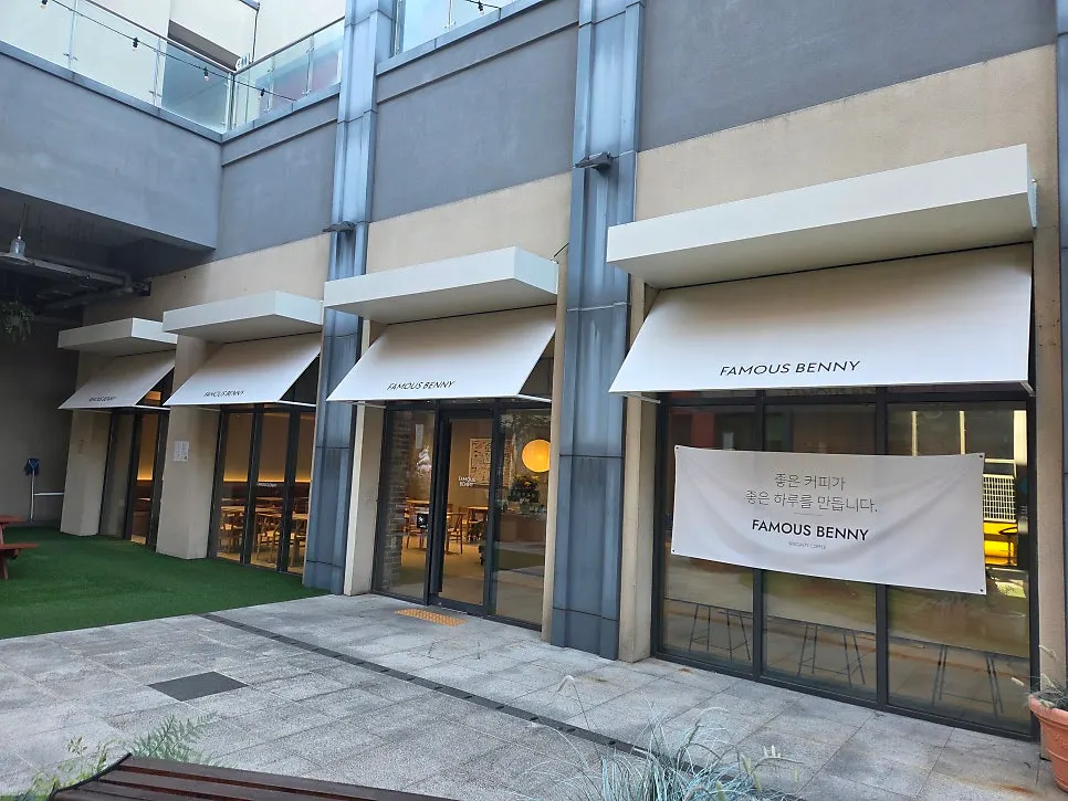 Exterior of Famous Venny with ivory awning and floor-to-ceiling windows
