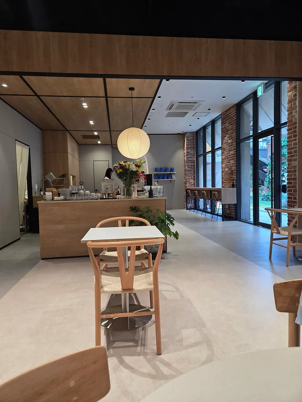Bar table seating by the floor-to-ceiling windows