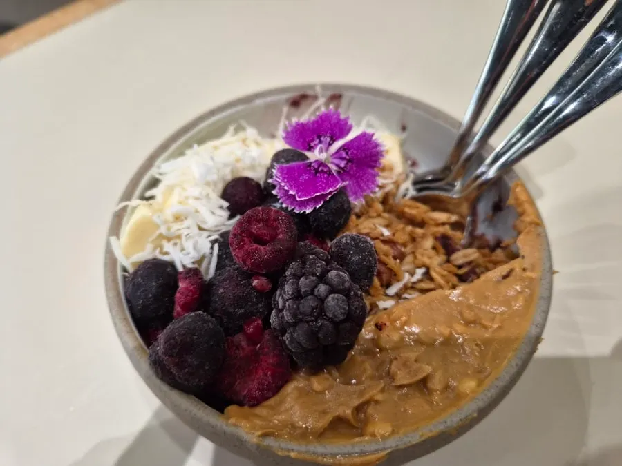 Acai bowl topped with berries, banana, and granola