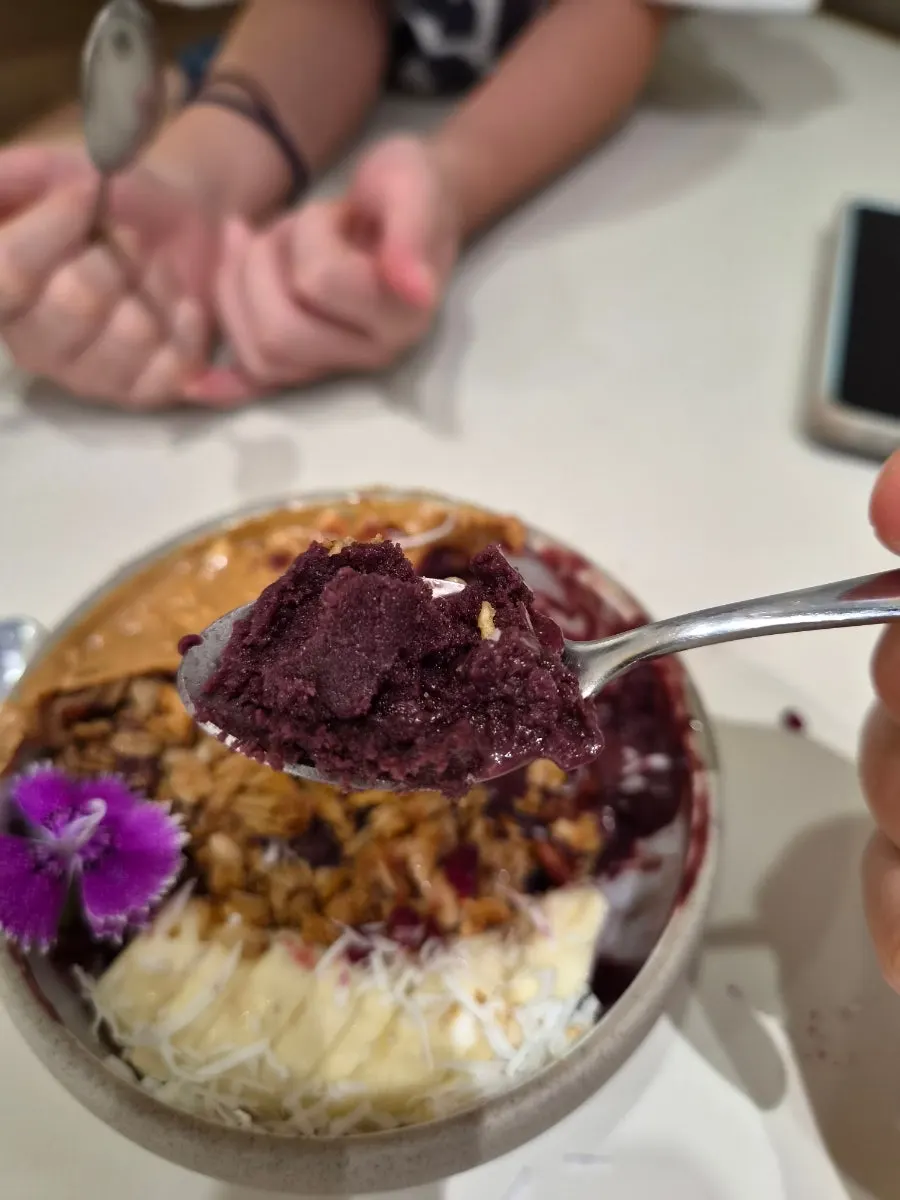 Scooping a spoonful of the acai bowl