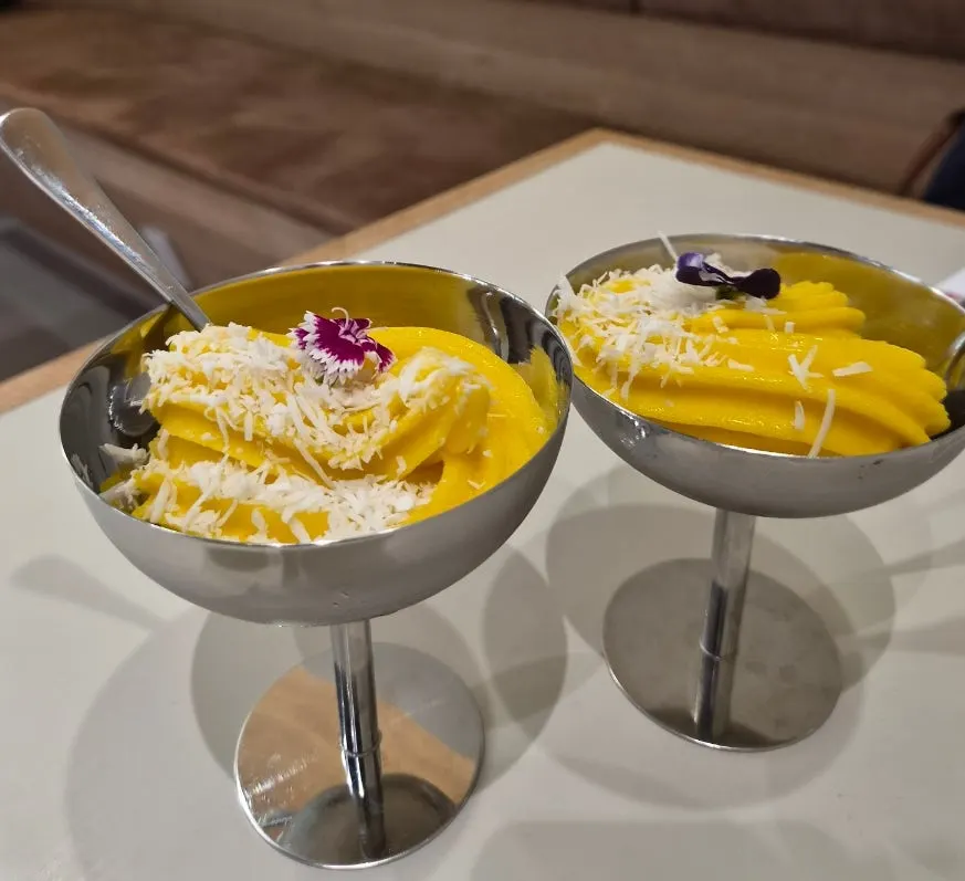 Mango coconut gelato served in a stainless cup
