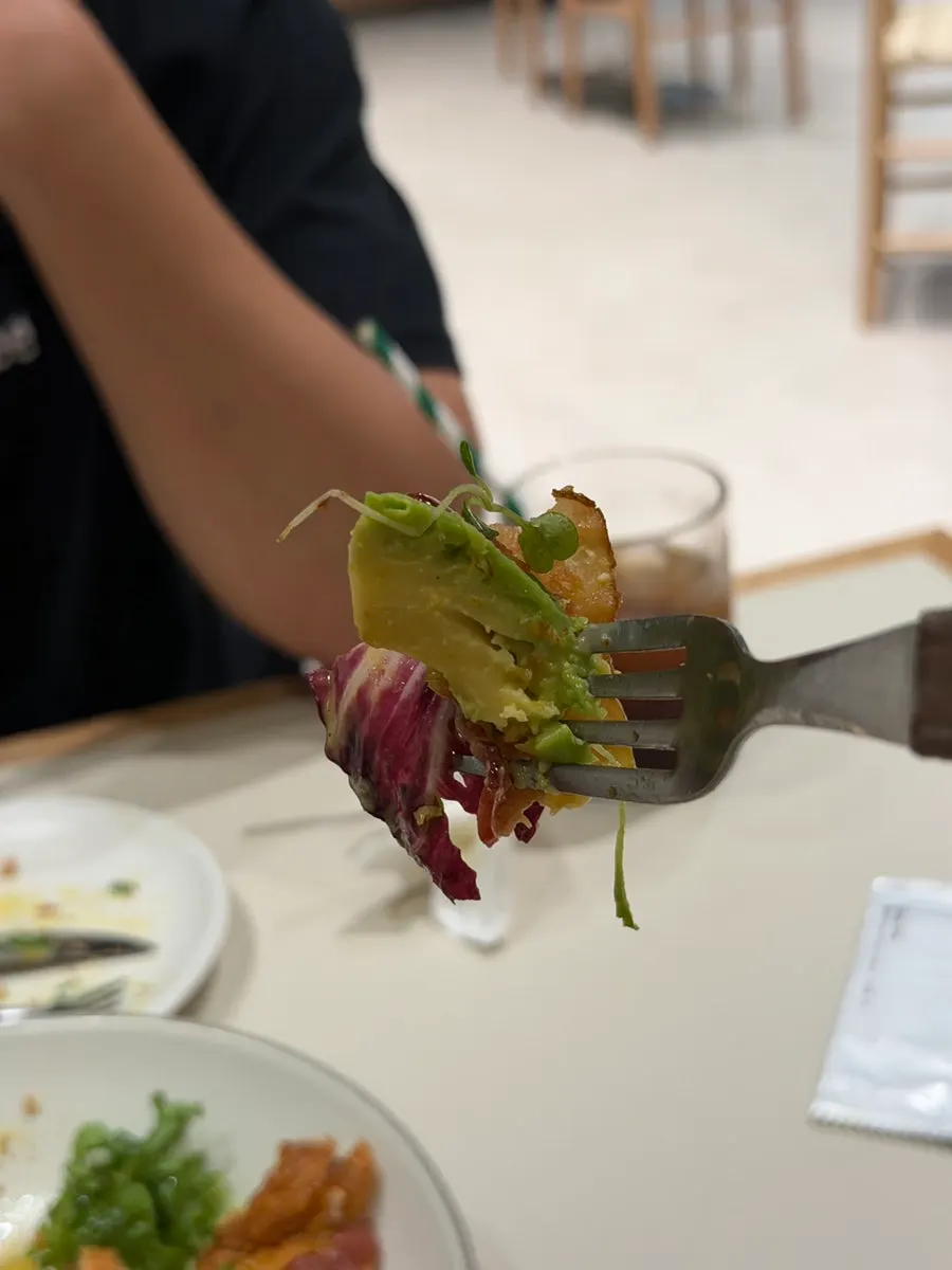 A bite of brunch served with avocado