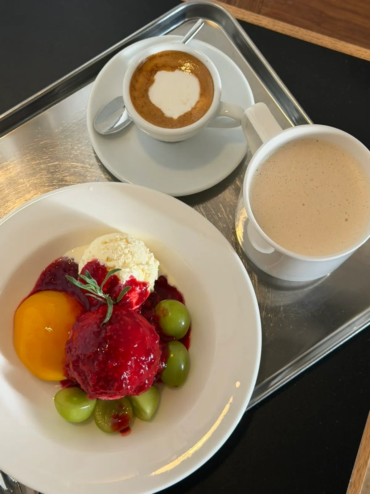 Peach melba dessert piled with berry sauce
