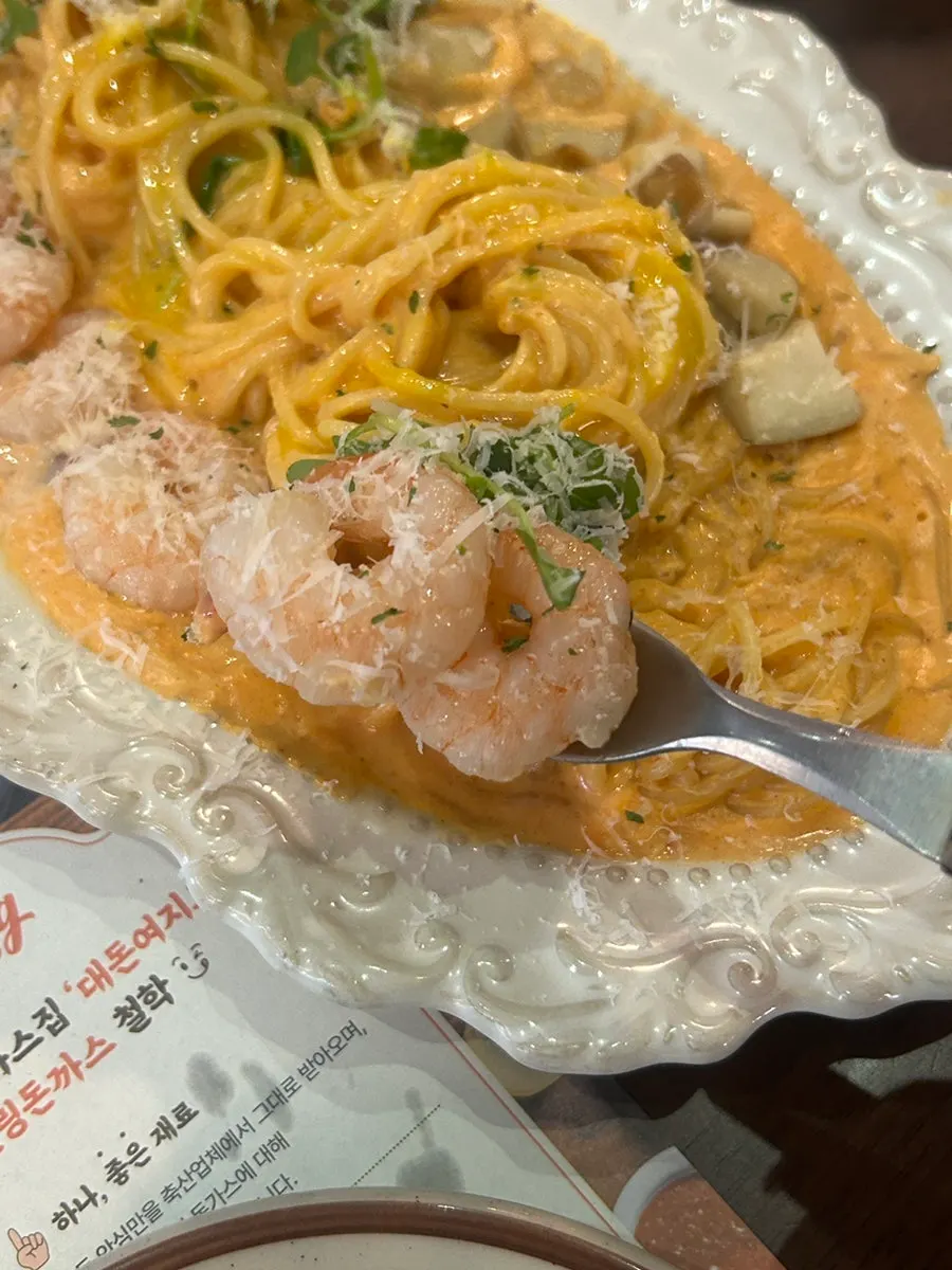Shrimp rosé pasta topped with grated cheese