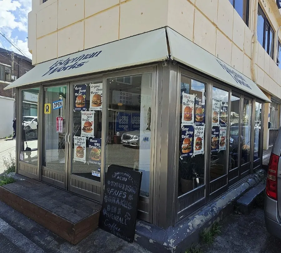Fisherman Works entrance door with burger photos on it