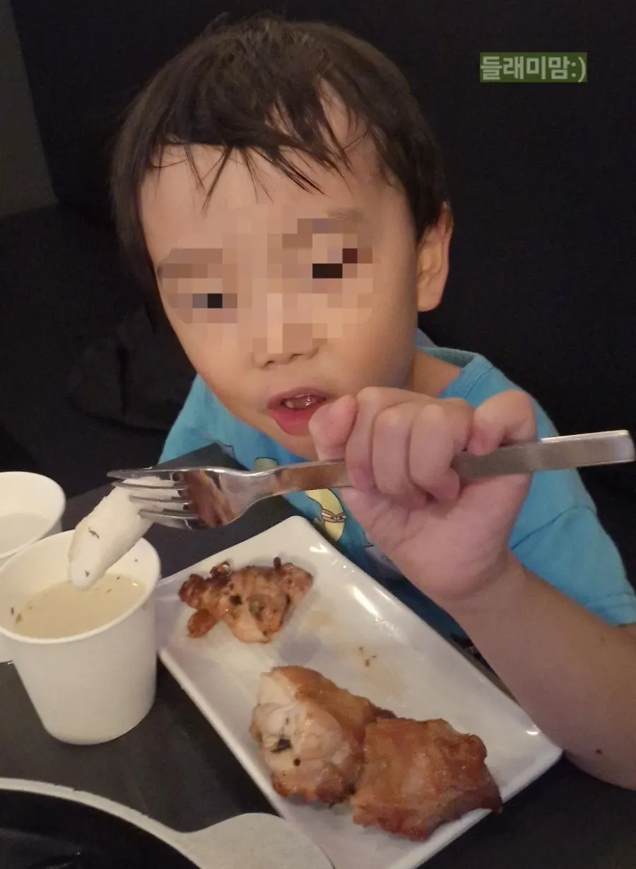 Vertical photo of the child's seat as she starts eating chicken