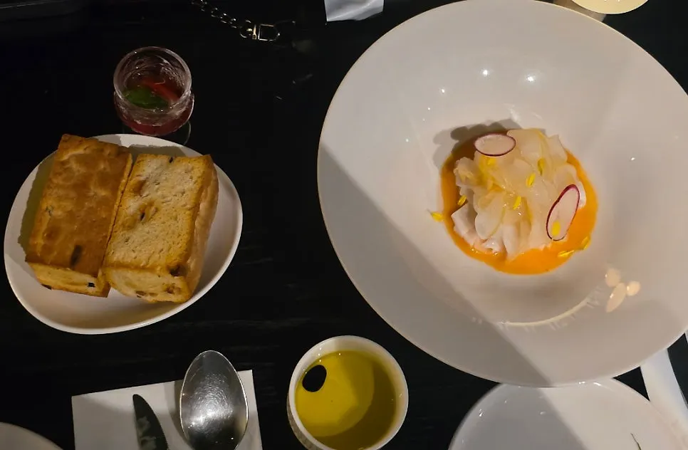 Carpaccio topped with smoked squid and melon